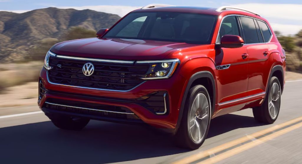 A red 2024 Volkswagen Atlas is shown driving on the road, showcasing it's size and style! Shop for your new Volkswagen Atlas near Greenville at Volkswagen of Spartanburg today.
