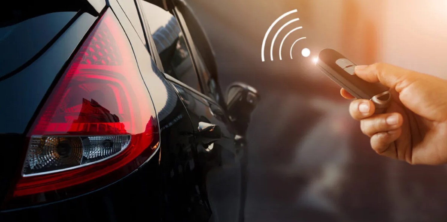 The image showcases a vehicle next to a human hand holding a keyfob, illustrating the key syncing to the vehicle. Learn how to sync your keyfob to your Volkswagen from VW of Spartanburg today!